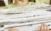 girl recycling newspapers